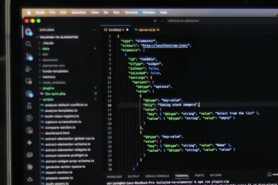 Developer working with code on a laptop