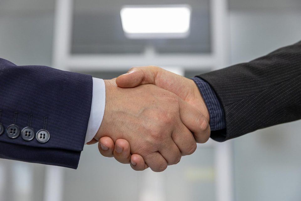 Two business partners shaking hands